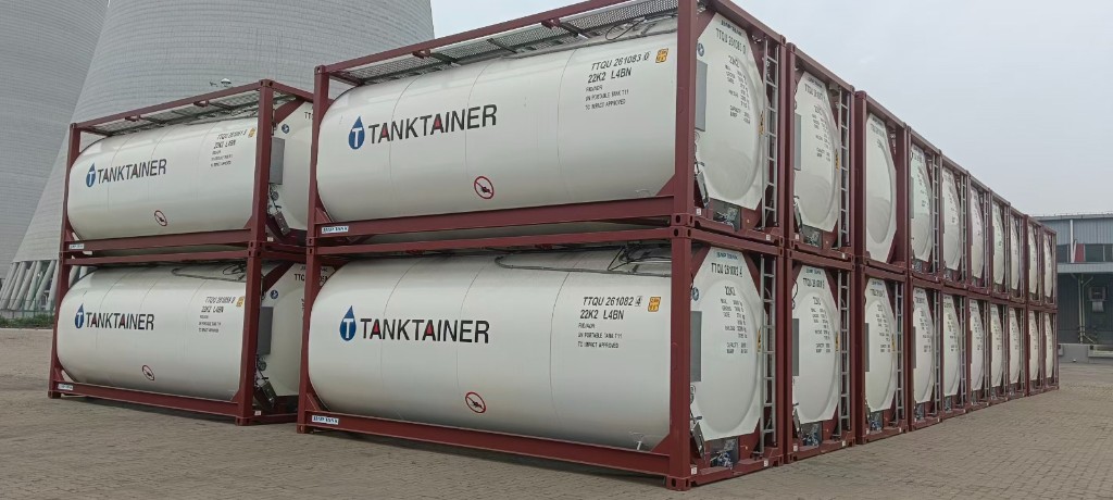 Blue-framed tank containers stacked several tiers high at a depot